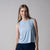 Gray background, image of a female model wearing a women's court tank, blue breeze.