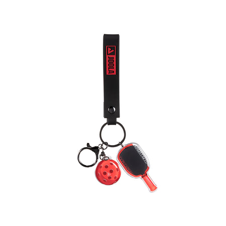 Agassi keychain with paddle and ball charms on a white background.