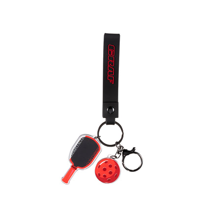 Graf keychain with paddle and ball charms on a white background.