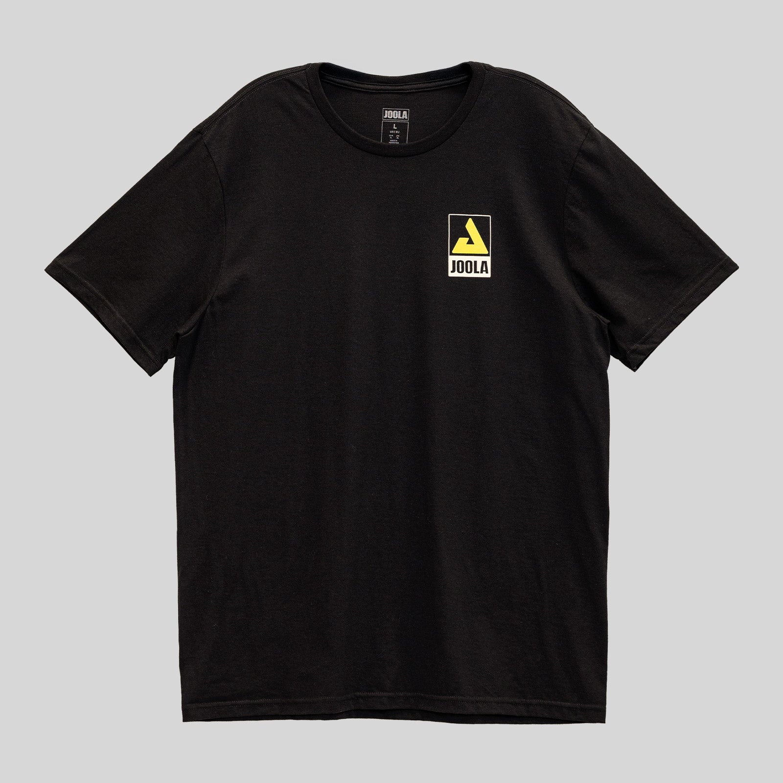 Gray background, black JOOLA t shirt with yellow trinity logo and JOOLA word mark over the left chest.