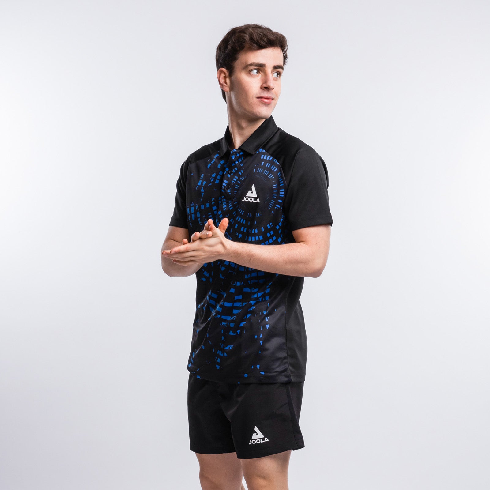 Image of a model wearing JOOLA's Centrela Table Tennis Shirt in Black and Blue.