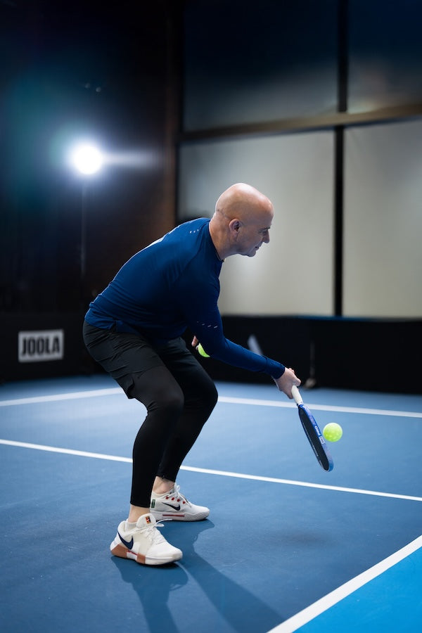 Andre Agassi scooping a return up near the kitched with his Agass Pro V.