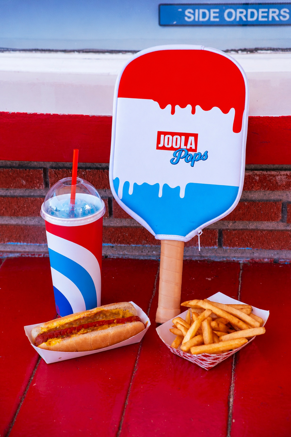 JOOLA Rally Rocket Pickleball paddle with JOOLA logo, hot dog, fries, and drink on a red surface with 'Side Orders' text.