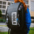 Person wearing a black backpack with JOOLA branding outdoors. Three different JOOLA Pro IV keychains.