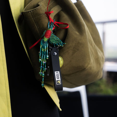 Close up image of the JOOLA Scorpeus Pro IV keychain hanging from a bag.