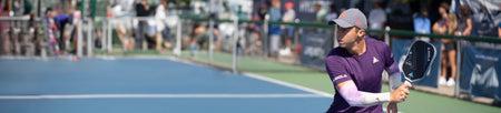 Horizontal banner image showing Ben Johns on a pickleball court wearing a JOOLA shirt and hat and holding the JOOLA Perseus pickleball paddle.