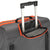 White Background Image: Charcoal colored vision suitcase. Orange zipper area, pull up handle extended.