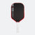 Pickleball paddle with black surface, red border, and white handle on a white background