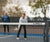 Image of the JOOLA Pro Pickleball net in the foreground of the image and Andre Agassi and Stefi Graf in the background.