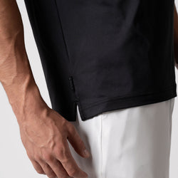 Close up image of the JOOLA logo tag on the side of the JOOLA men's club short sleeve shirt, black. Category