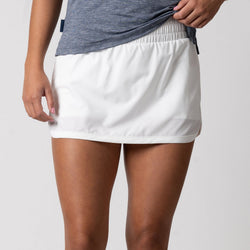 Close up image of a female model wearing a JOOLA Women's Club Skort, White. Category
