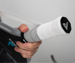 Close up image of someone putting new grip on a JOOLA Pickleball paddle handle.  Category