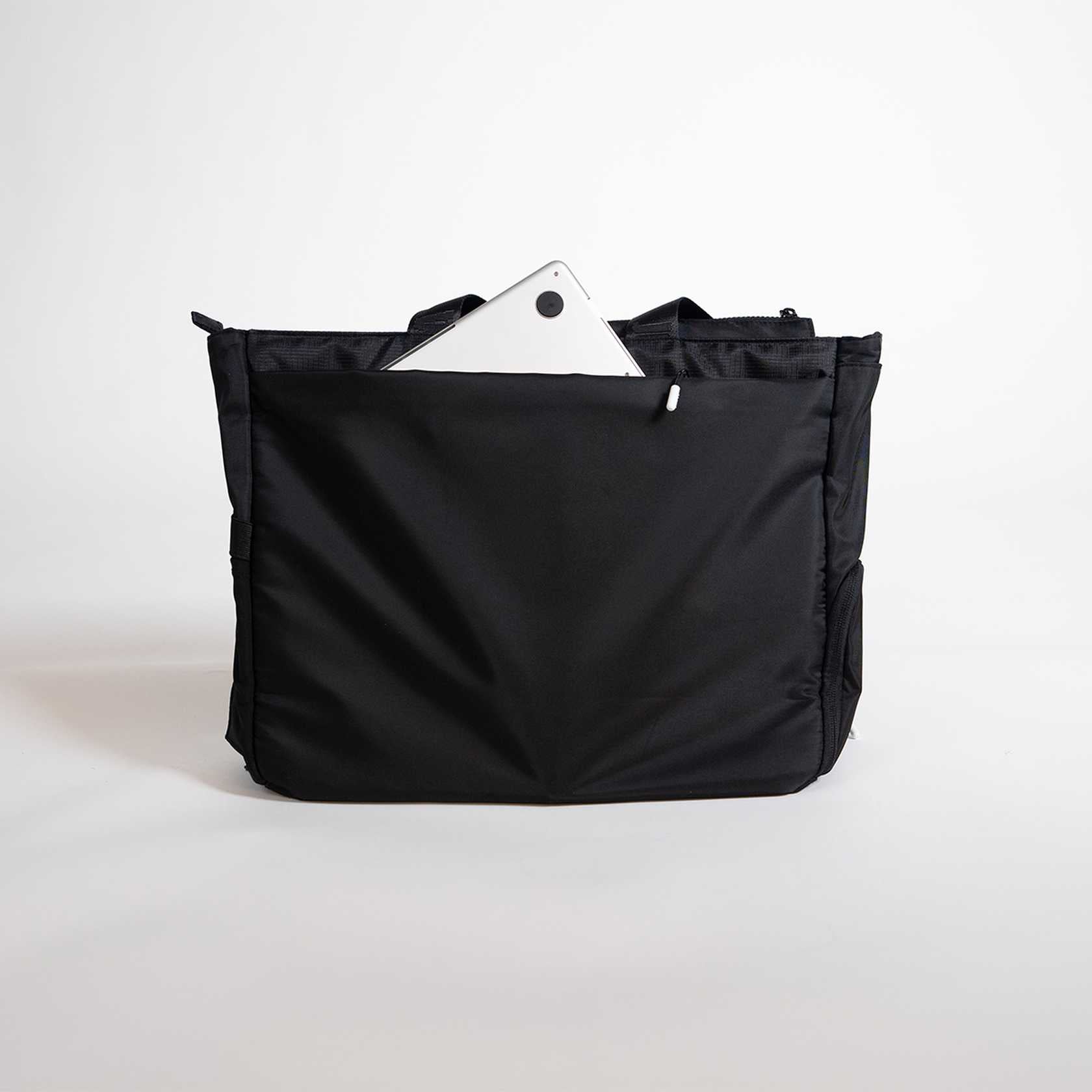 Black bag with a white tablet inside on a light gray background