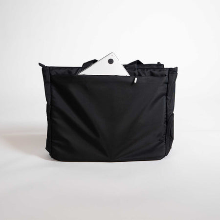 Black bag with a white tablet inside on a light gray background