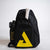 Black sling bag with yellow logo and water bottle on a light gray background