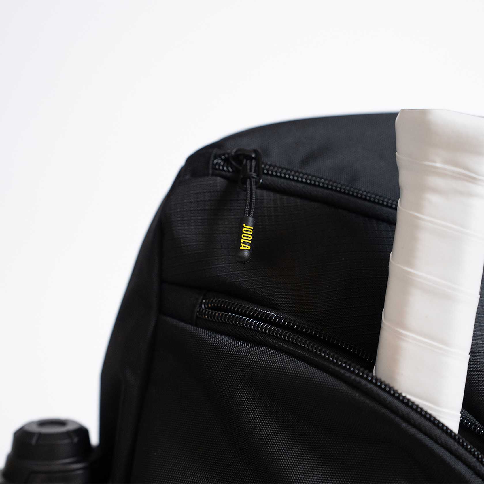 Black backpack with a yellow JOOLA brand logo on a white background