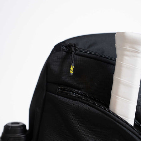 Black backpack with a yellow JOOLA brand logo on a white background