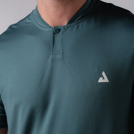 Product image of a club green colored JOOLA Men's Court Polo. JOOLA trinity logo is on the left side of the models chest. 