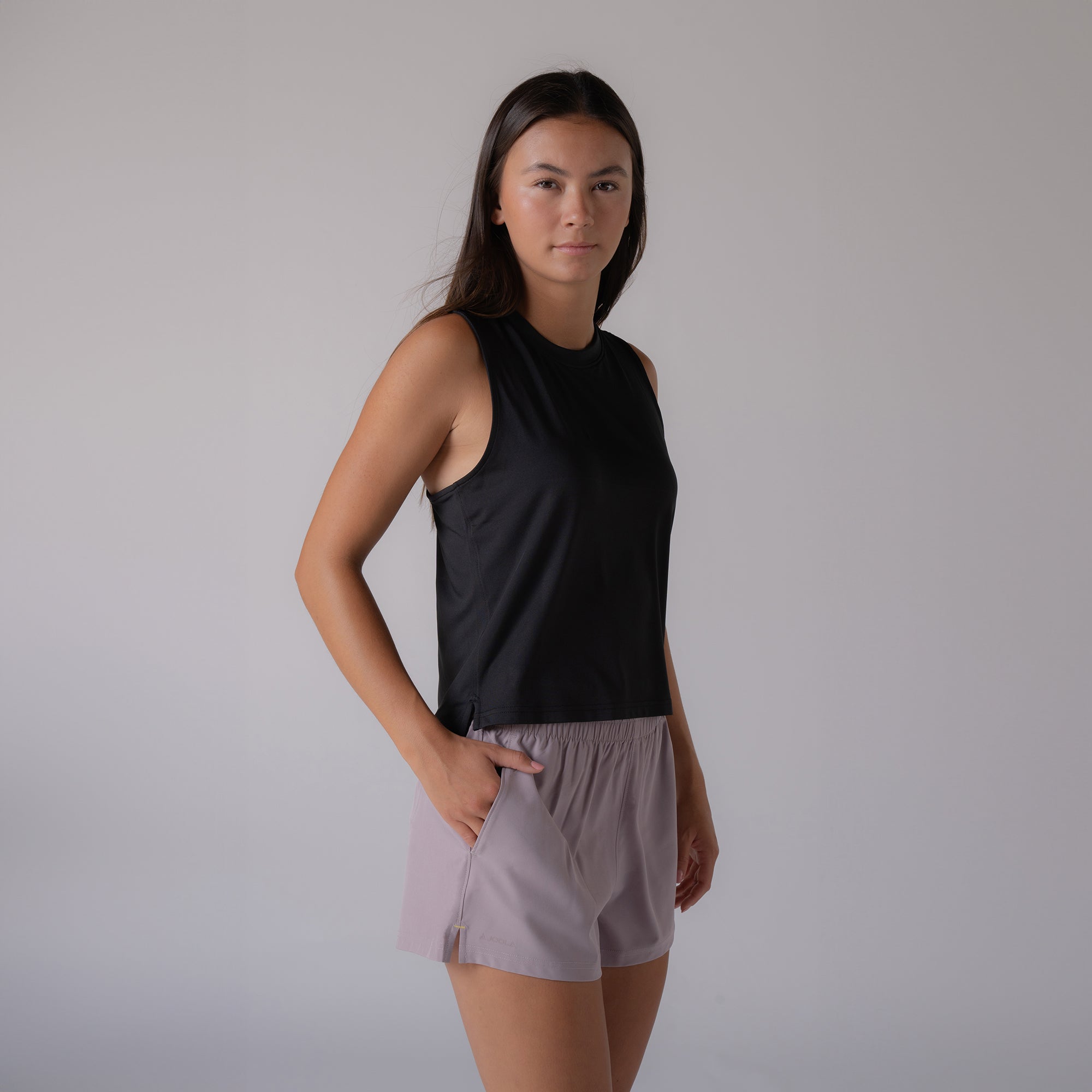 Image of a female model wearing a black JOOLA women's court tank top.