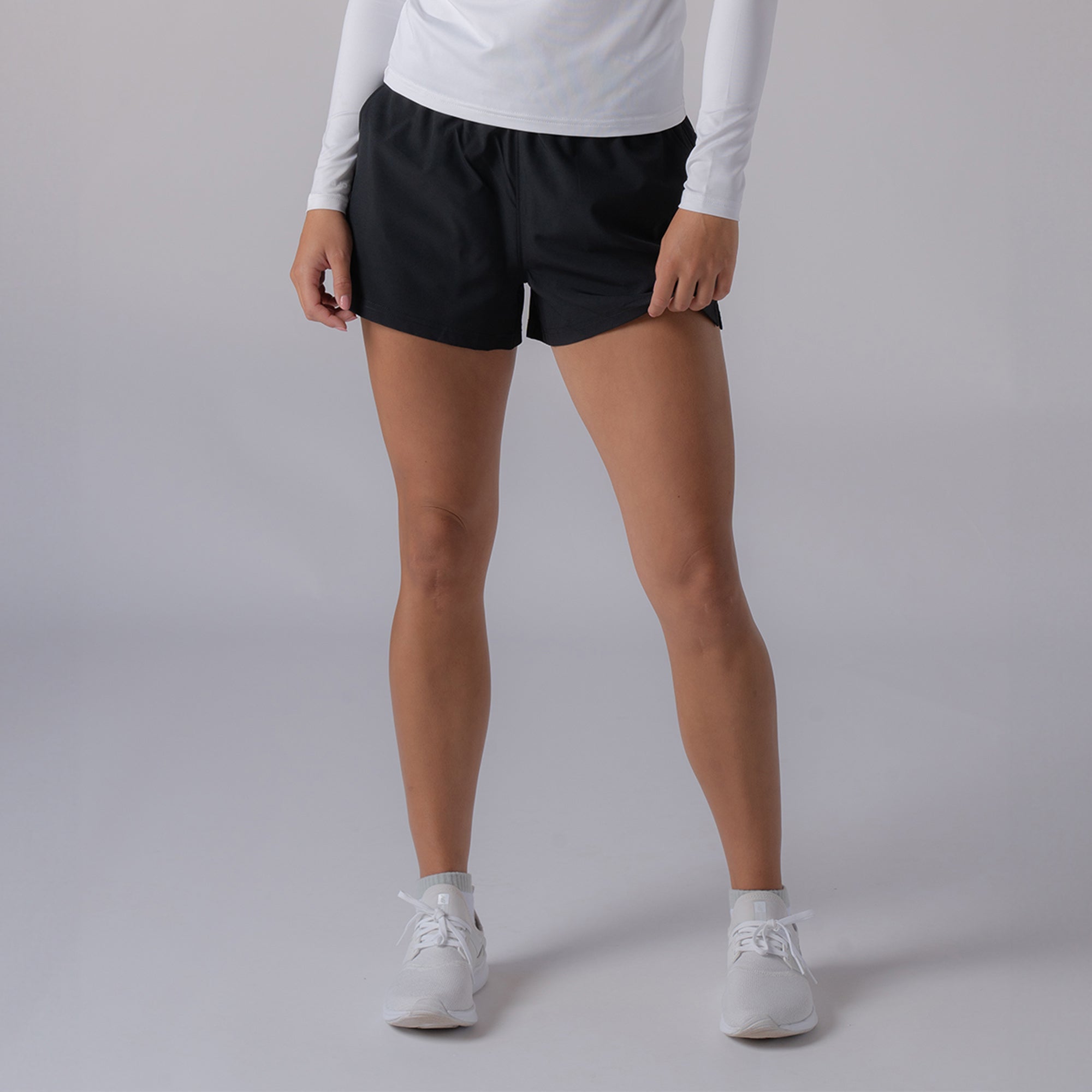 Product image of a model wearing the JOOLA women's woven shorts, black.