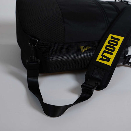 Black bag with a yellow strap featuring the 'JOOLA' brand on a light gray background