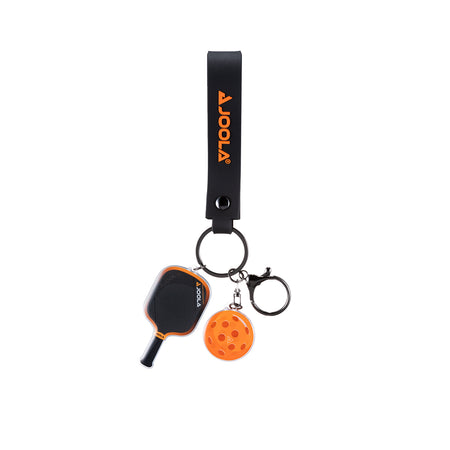 White background, product image of the JOOLA Collin Johns 3S paddle and ball keychain. Orange.