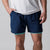 Male model wearing a pair of JOOLA Men's 2 in 1 shorts, navy.