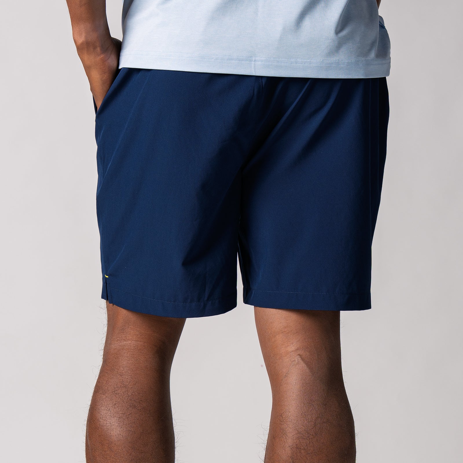 Close up image of the back of a pair of JOOLA men's club shorts, navy.