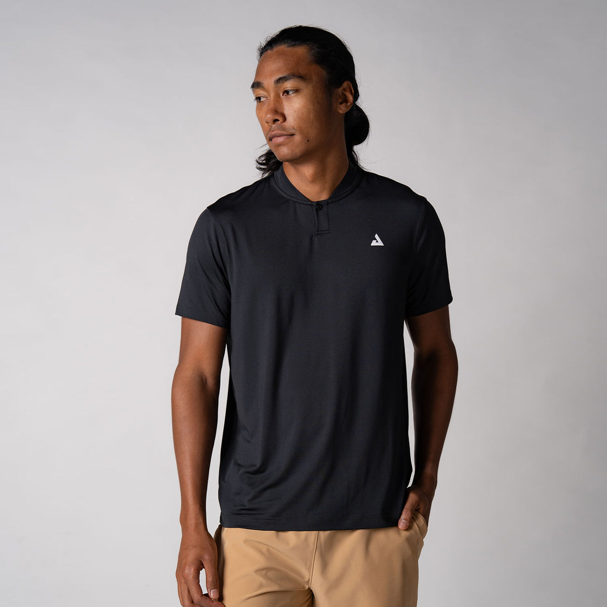 Image of a male model wearing a JOOLA Men's Court Polo, Black with a White JOOLA trinity logo over the left chest.