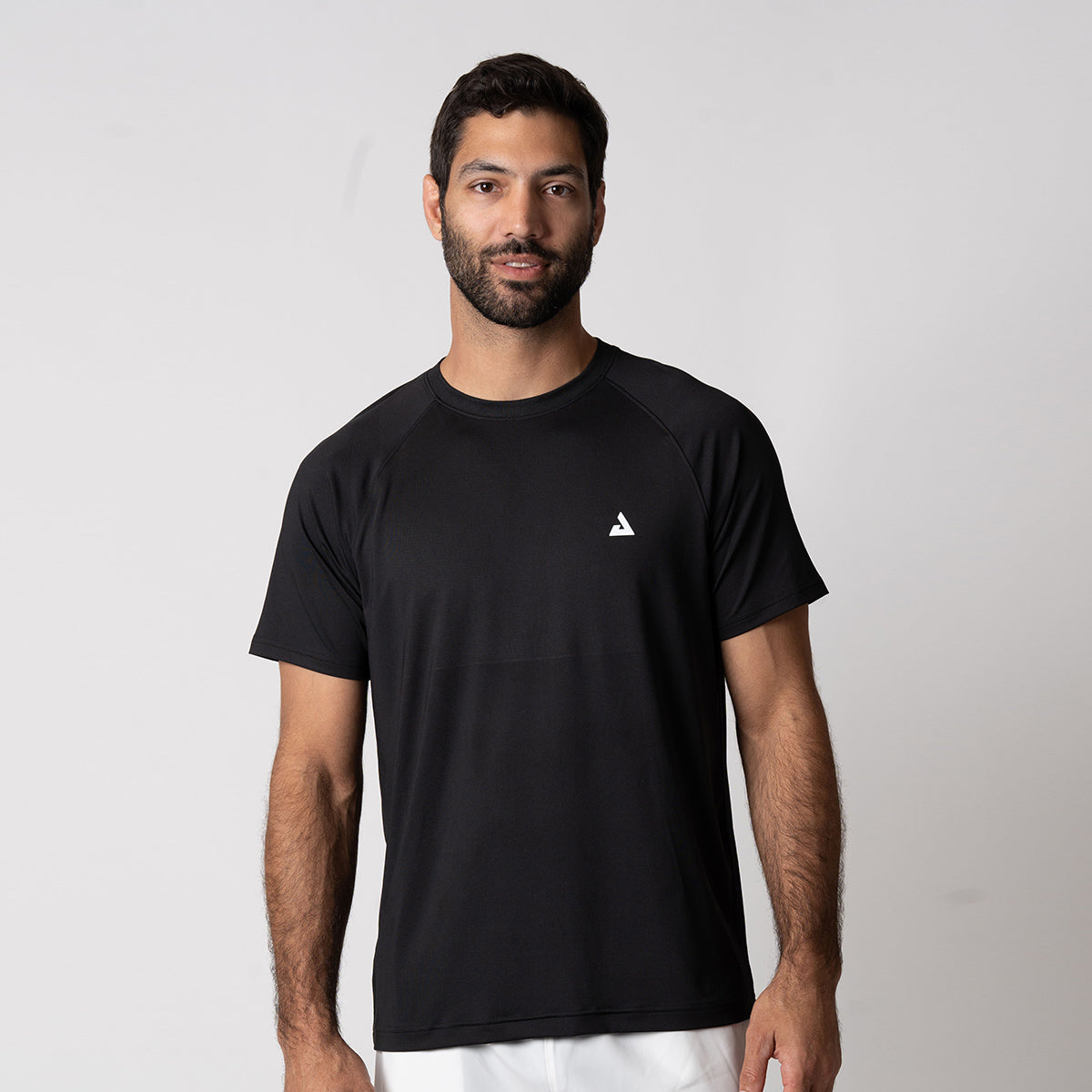 Image of a male model wearing a JOOLA men's court short sleeve shirt, black.