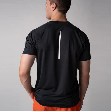 Image of a male model wearing a JOOLA Men's Court Short Sleeve shirt. The image shows the back of the shirt, black shirt with white logo.