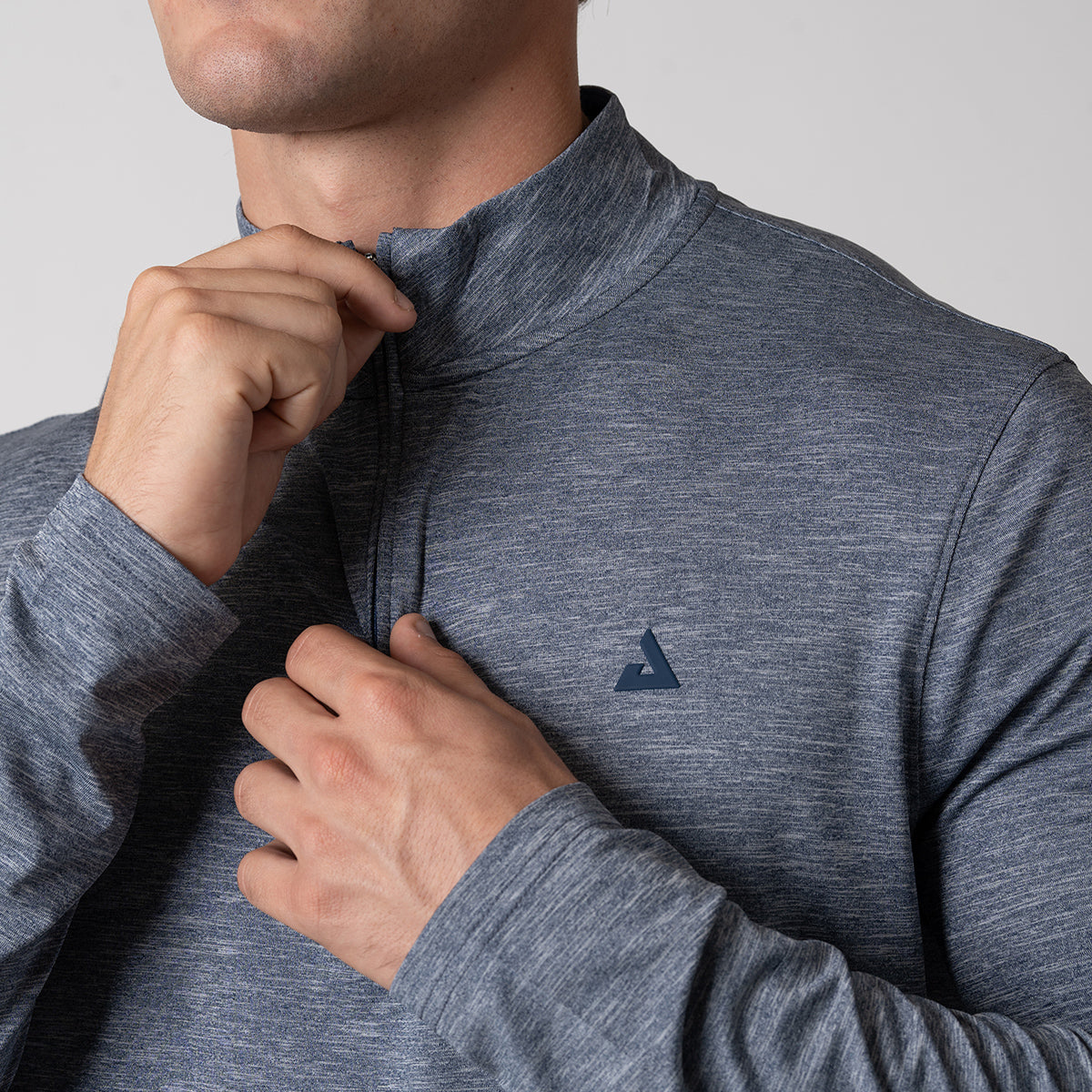 Close up image of the JOOLA trinity logo on the JOOLA Men's Quarter Zip Pullover, Navy Heather.