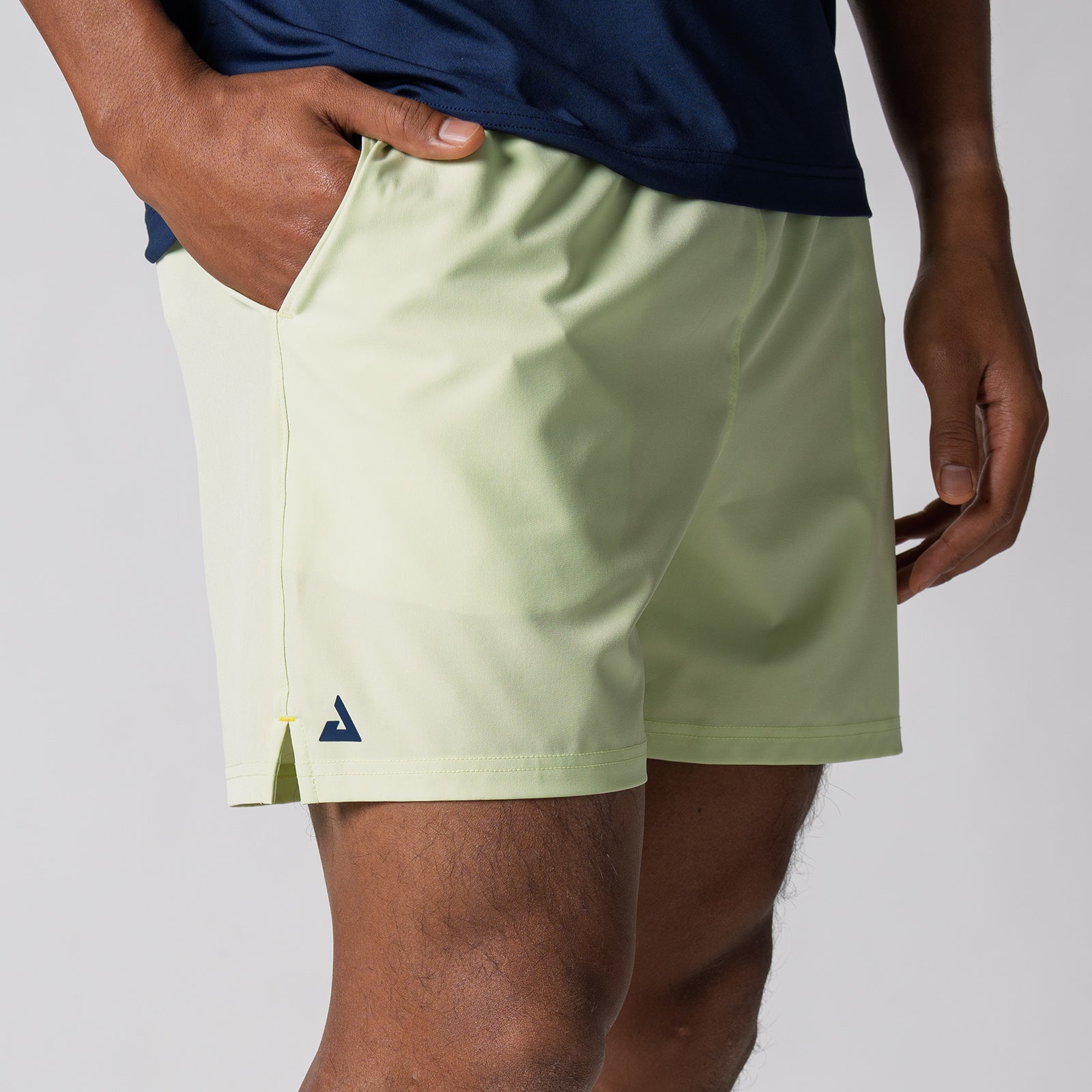 Close up image showing the side of a pair of JOOLA Men's Woven Shorts, 5-inch inseam, key lime.