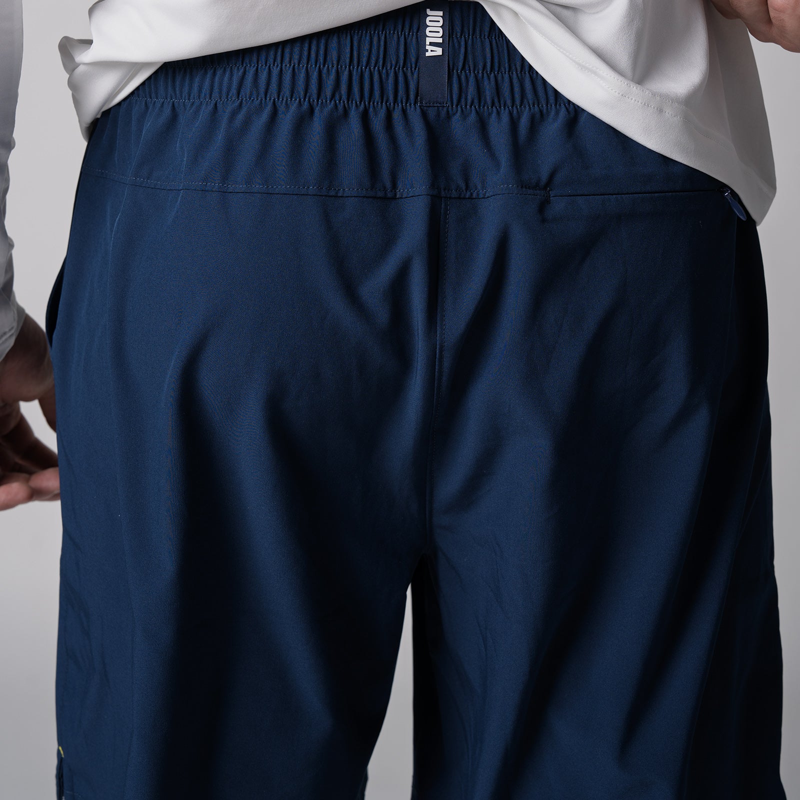 Close up image showing the back of a pair of JOOLA Men's Woven Shorts, 7-inch, navy.