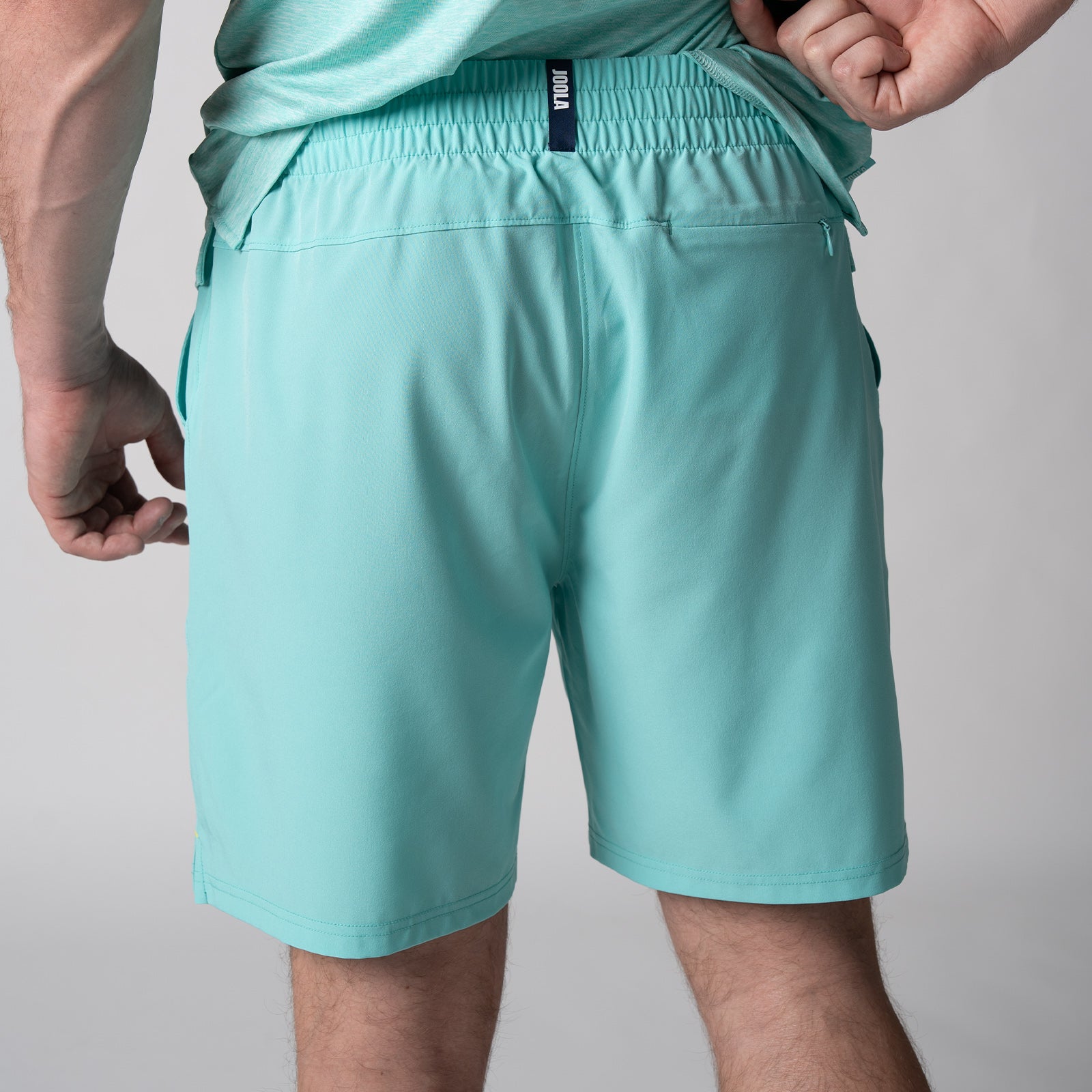 Close up of the back of a pair of JOOLA Men's Woven Shorts, 7-inch inseam, tropical tide.