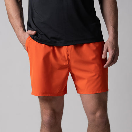 Gray background, close up image of the front of a pair of JOOLA Men's Woven Shorts, 5-inch, poppy red.