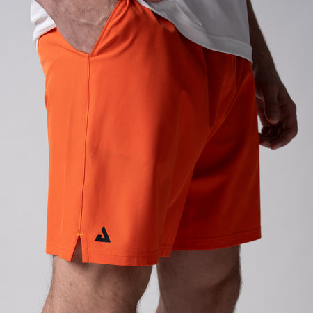 Gray background, close up image of the JOOLA Men's Woven Shorts, 7-inch, poppy red color.