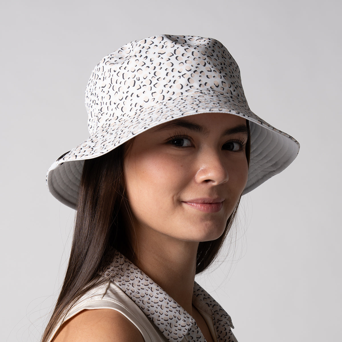 Close up image of a female model wearing a 2025 Unisex Reversible Bucket hat.