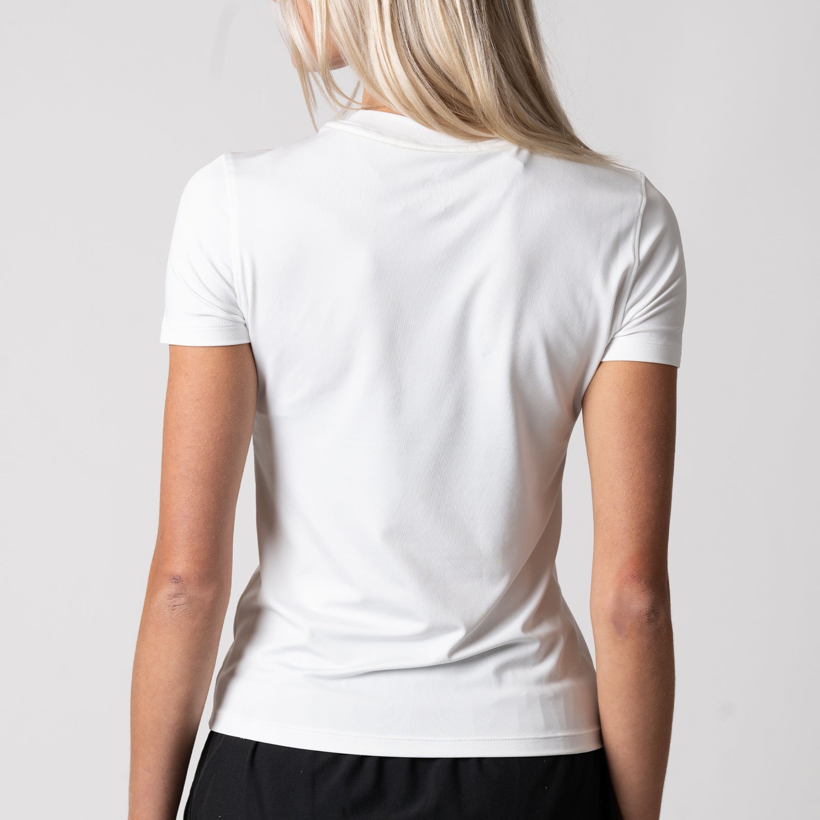 Image of the back of a JOOLA women's club short sleeve shirt, white.