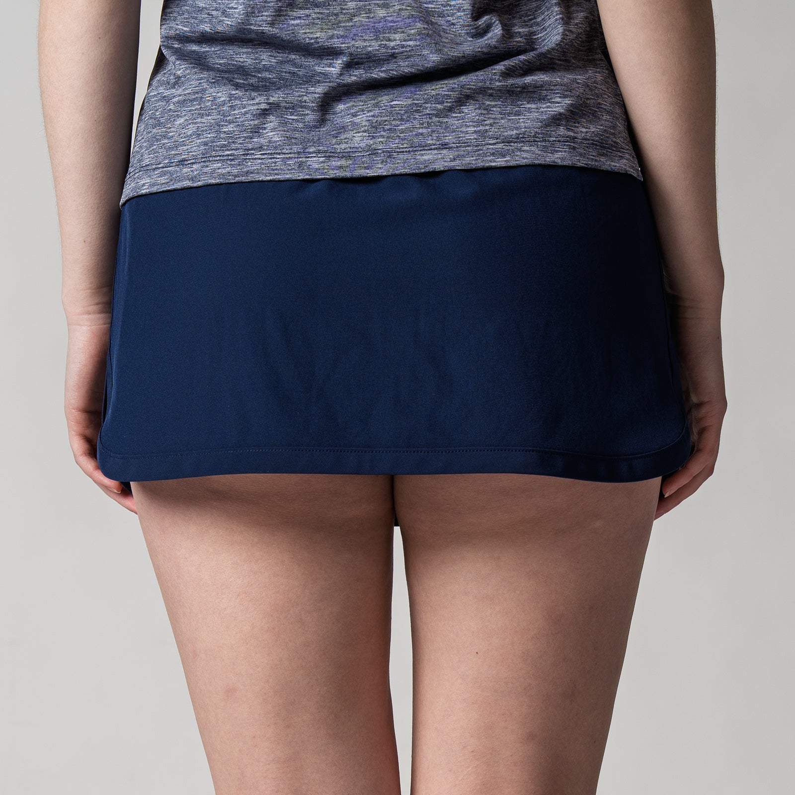 Close up image of the back of a JOOLA women's club skort, navy.