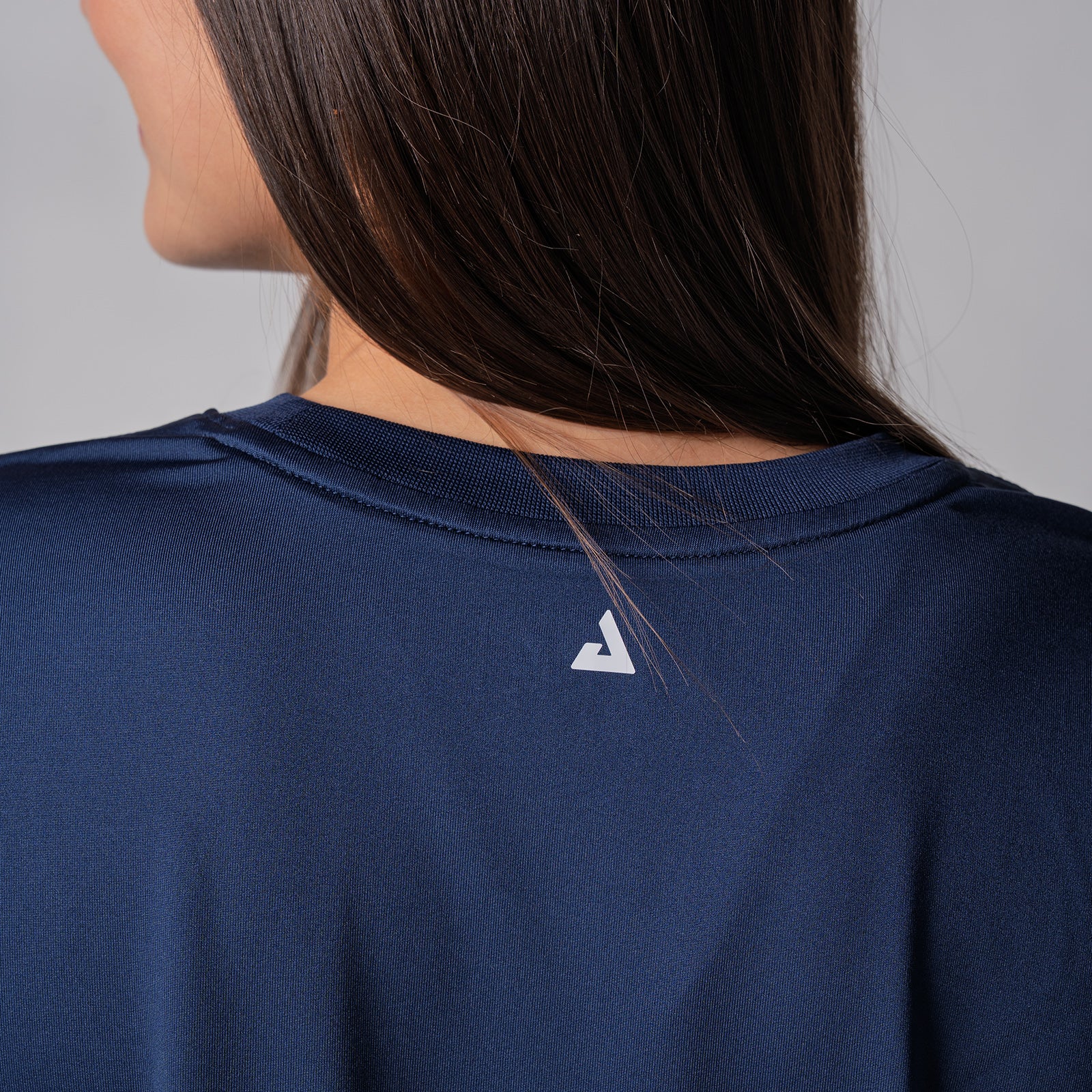 Detailed JOOLA Trinity logo on the back of a JOOLA Women's Court Crop Tee, Navy.