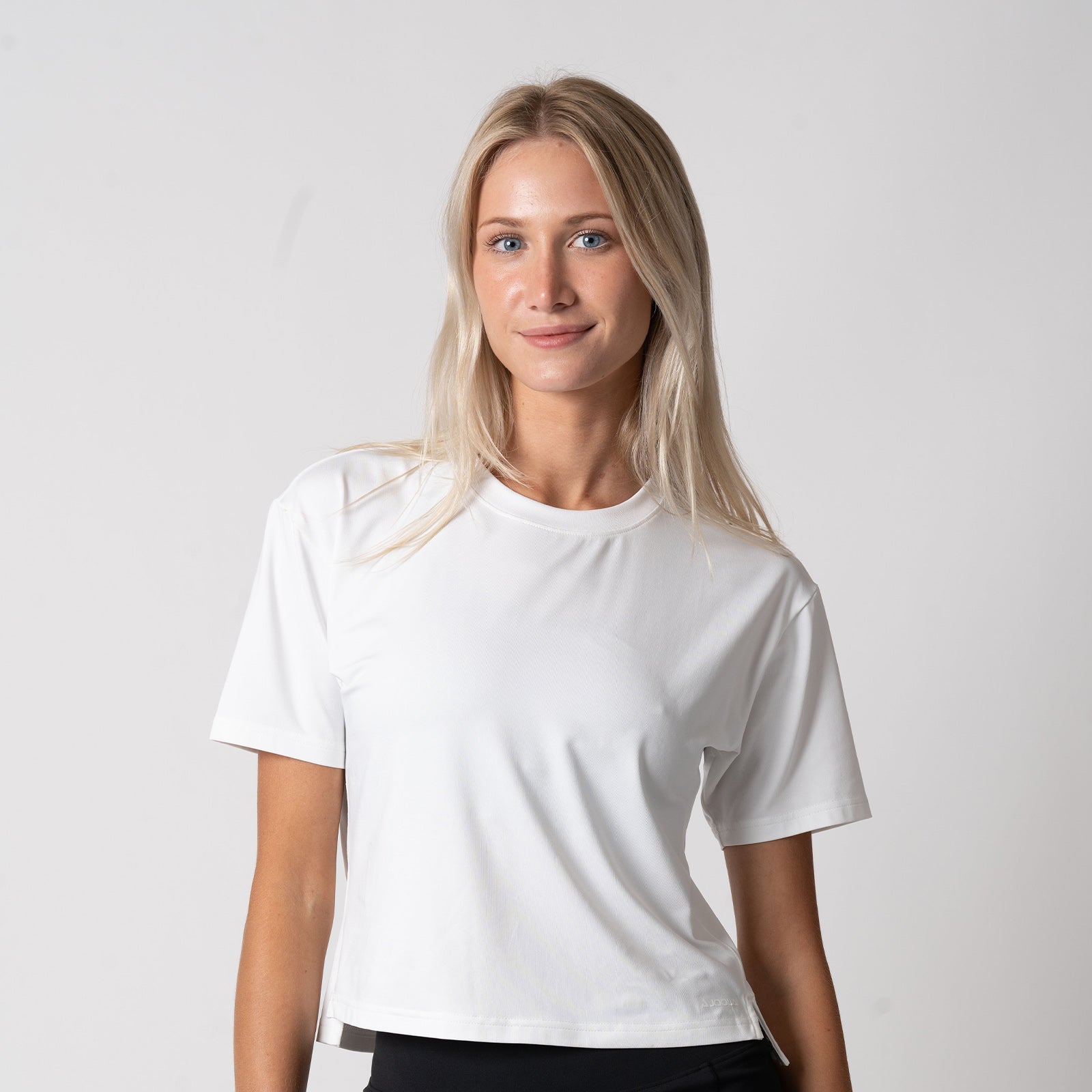 Image of a female model wearing a JOOLA Women's Court Crop Tee, White.