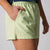 Close up of the JOOLA logo on a pair of JOOLA Women's Court Woven Shorts, Key Lime.