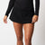 Image of a female model wearing a JOOLA Women's Pickleball Skort, Black.