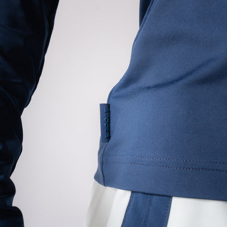 Close up image of the JOOLA logo tag on the side of a JOOLA Women's Quarter Zip Pullover, Navy.