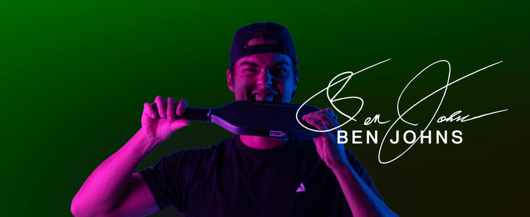 Ben Johns biting down on a JOOLA 3S Dual Pickleball Paddle with his name and signature over the image.