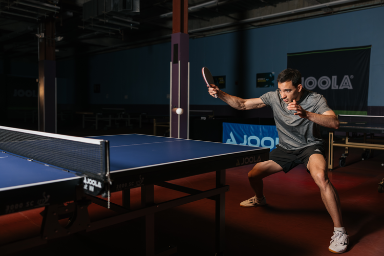JOOLA Table tennis pro Hugo Calderano returning a shot on a JOOLA table tennis table.