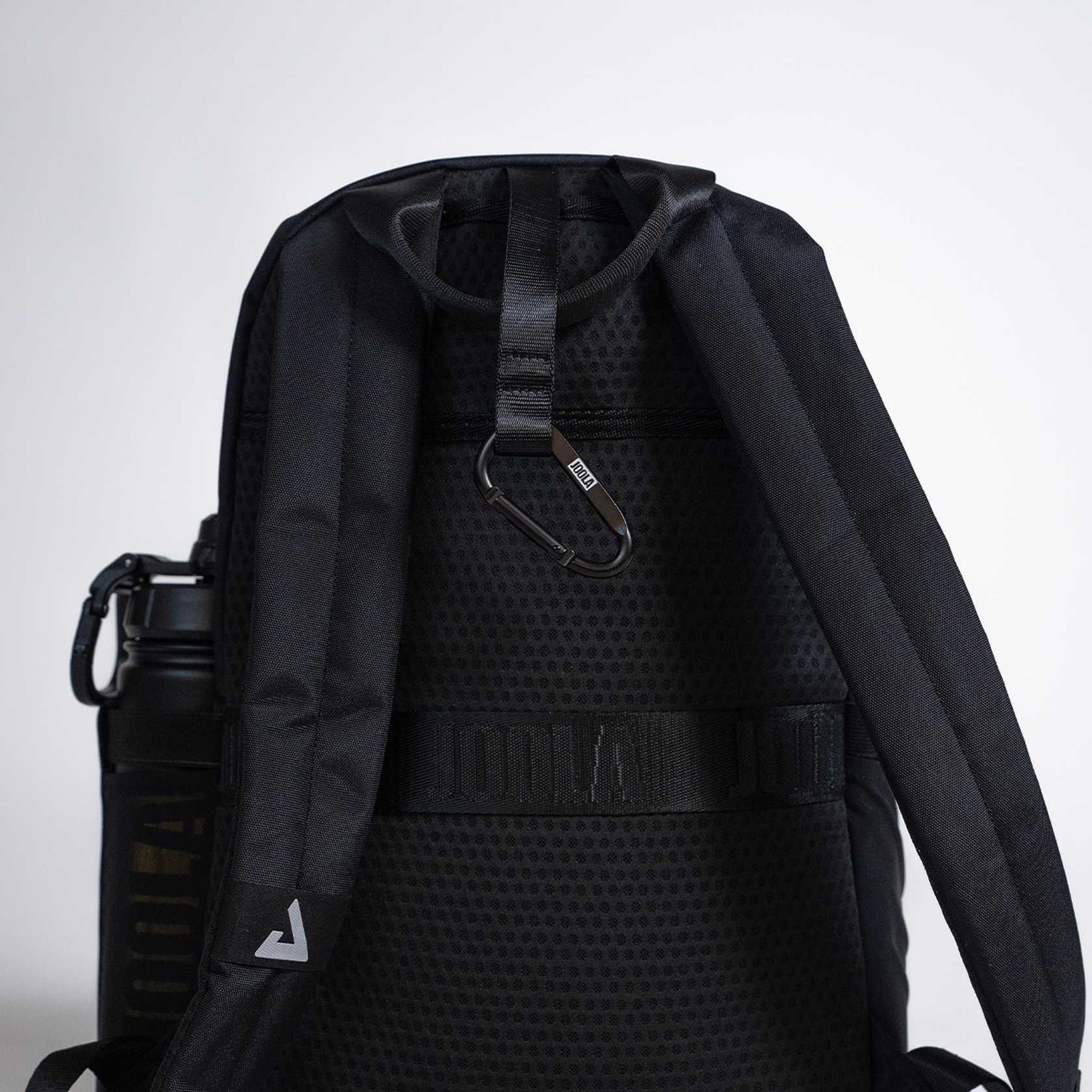 Black JOOLA backpack with a water bottle holder on a light gray background