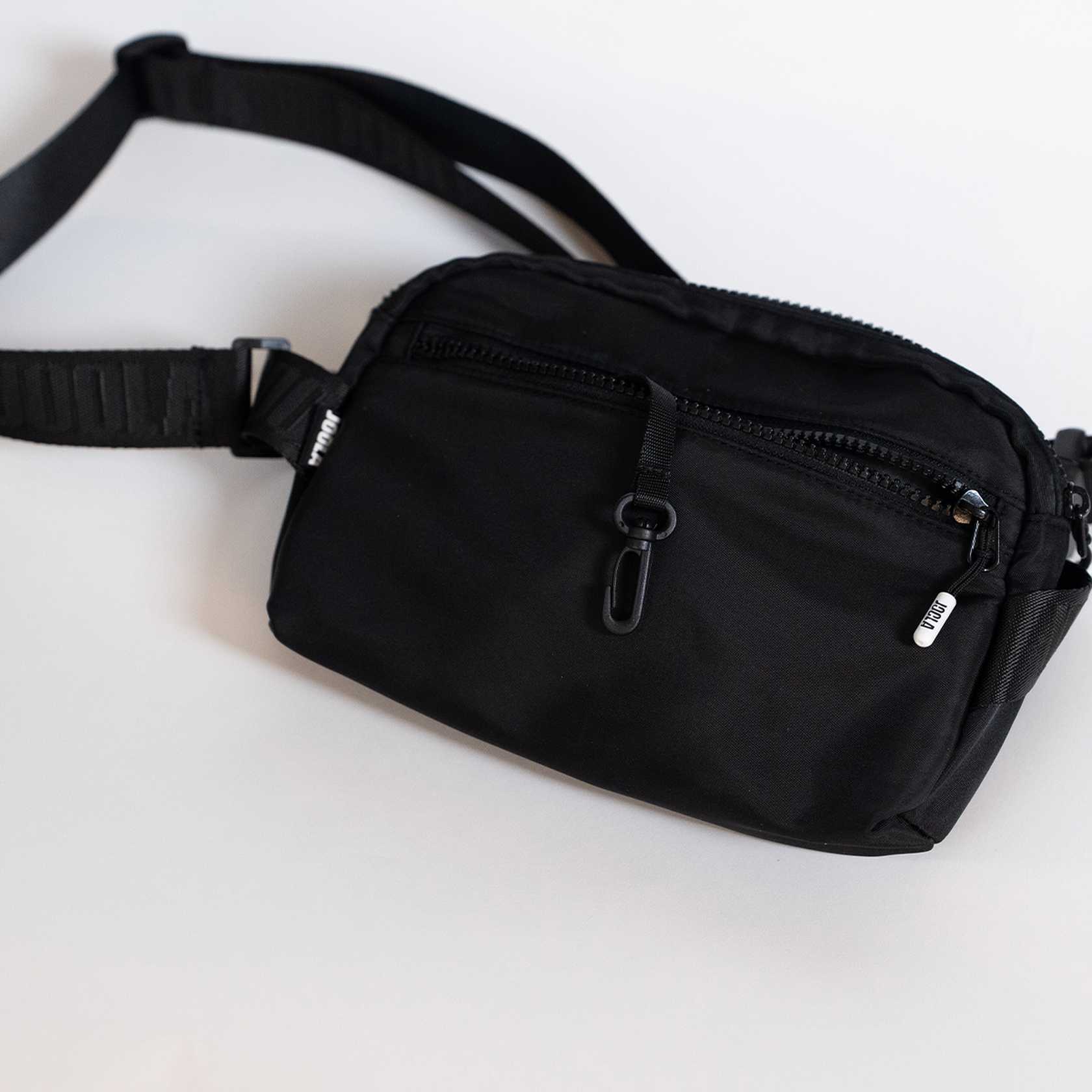 Black waist bag on a white background.