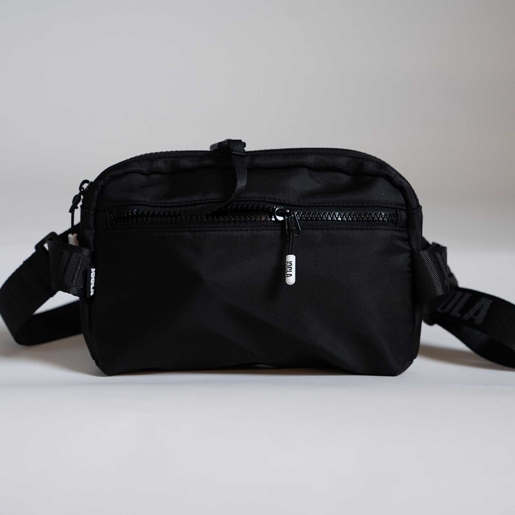 Black waist bag on a light gray background